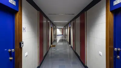 a long hallway with blue and white walls and a long aisle at Bright 2BR Flat near Praça da Galiza by LovelyStay in Porto
