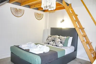 a room with a bed with a ladder on it at Art Quarter Oporto City Center in Porto