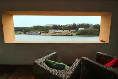 two chairs in a room with a view of a river at Refúgio Douro à Vista in Porto