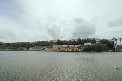 a large body of water with a city in the background at Refúgio Douro à Vista in Porto