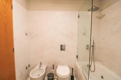 a bathroom with a toilet and a sink and a shower at Refúgio Douro à Vista in Porto