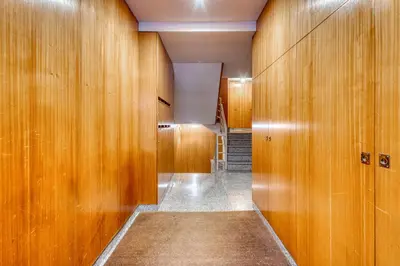 a hallway with wood paneled walls and a staircase at 700 Verde Esperança in Porto