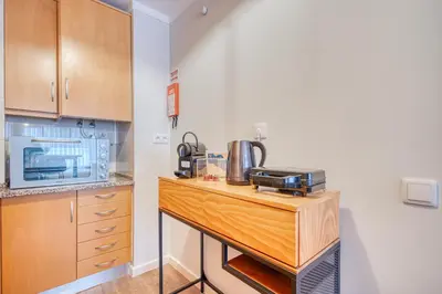a kitchen with a wooden counter top with a microwave at 700 Verde Esperança in Porto