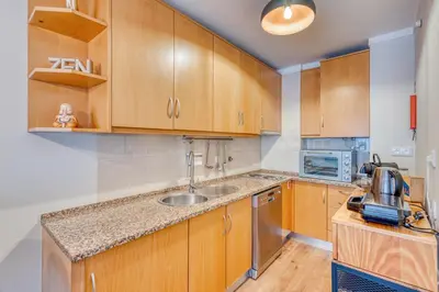 a kitchen with wooden cabinets and a sink at 700 Verde Esperança in Porto