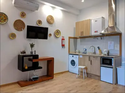 a kitchen with a sink and a stove at Porto-Stone Wall Apartment in Porto