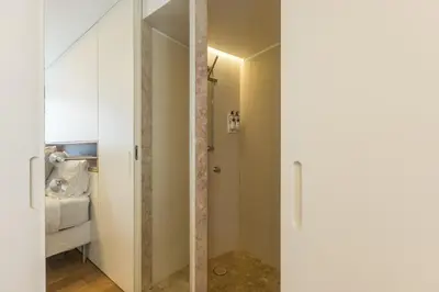 a bathroom with a shower stall and a toilet at Discovery Luxury Historic House At Rua das Flores in Porto