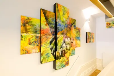 a group of paintings hanging on a wall at Discovery Luxury Historic House At Rua das Flores in Porto