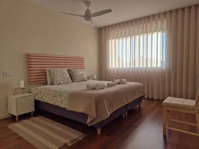 a bedroom with a large bed and a window at Sleep Swell in Porto