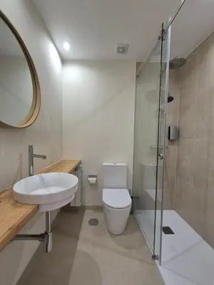a bathroom with a toilet and a sink and a shower at Sleep Swell in Porto