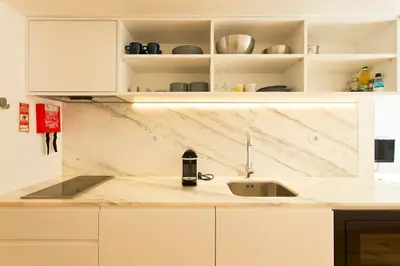 a kitchen with a sink and a counter top at APOSENTUS - Your home in Almada in Porto