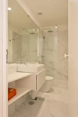 a white bathroom with a sink and a toilet at APOSENTUS - Your home in Almada in Porto