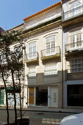 a large white building with balconies on a street at APOSENTUS - Your home in Almada in Porto