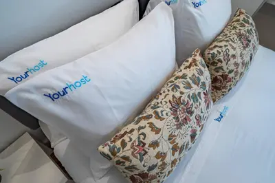 a bed with two pillows with the word yourself on them at New Alegria in Town 1 in Porto
