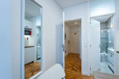 a bathroom with white cabinets and a glass door at New Alegria in Town 1 in Porto