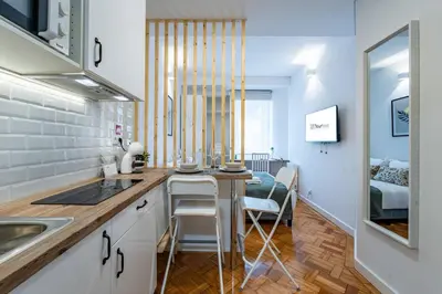 a kitchen with a table with plates and wine glasses at New Alegria in Town 1 in Porto