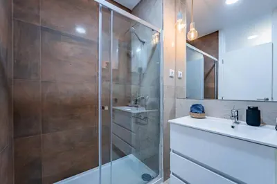 a bathroom with a toilet and a sink and a shower at New Alegria in Town 1 in Porto