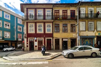 a white car parked in front of a building at WHome Trendy Cedofeita Loft - Luxe & Light-Filled in Porto