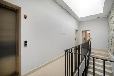 a hallway with a staircase in a building at WHome Trendy Cedofeita Loft - Luxe & Light-Filled in Porto