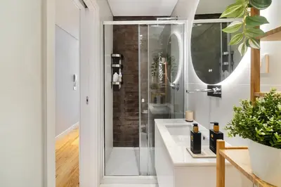 a bathroom with a shower and a sink at WHome Trendy Cedofeita Loft - Luxe & Light-Filled in Porto
