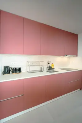 a kitchen with red cabinets and a sink at The Cale - Porto, Firmeza 2 in Porto