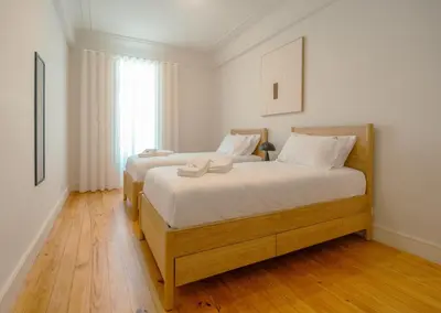 a bedroom with two beds and a window at The Cale - Porto, Firmeza 2 in Porto
