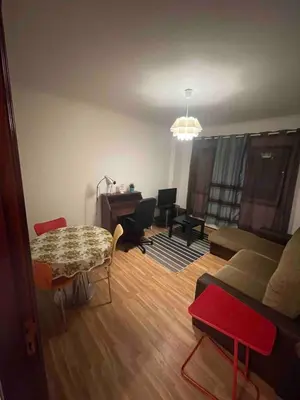 a living room with a table and a couch at T1 near El Corte Inglés in Vila Nova de Gaia