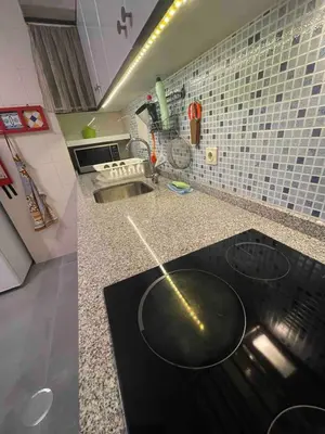 a kitchen with a black counter top in a kitchen at T1 near El Corte Inglés in Vila Nova de Gaia