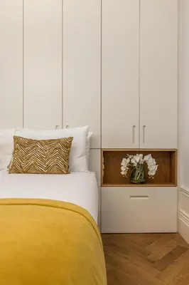 a bedroom with a bed and white cabinets at Bailarina Historic Luxury House at Rua das Flores in Porto