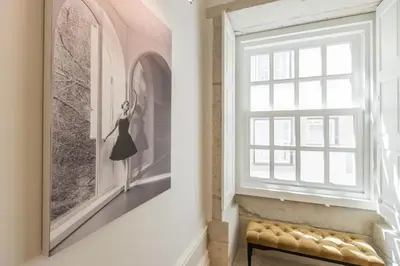 a window in a room with a picture of a woman at Bailarina Historic Luxury House at Rua das Flores in Porto