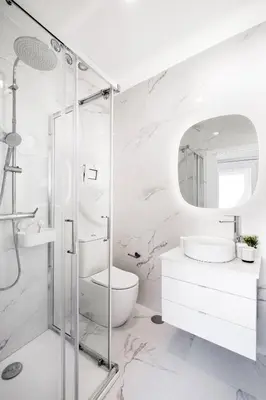 a white bathroom with a shower and a toilet at Riverside Studio By Luís Bridge, WOW & Half Rabbit in Vila Nova de Gaia