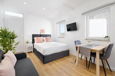 a bedroom with a bed and a table and a couch at Riverside Studio By Luís Bridge, WOW & Half Rabbit in Vila Nova de Gaia
