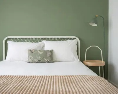 a bathroom with a bed and a shower and a sink at Magnolia Suites & Stays in Porto
