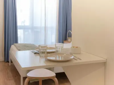 a bedroom with a bed with white sheets and pillows at Magnolia Suites & Stays in Porto