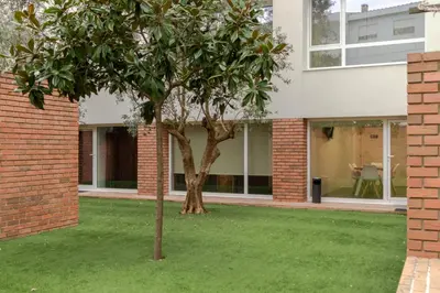 a living room with a couch and a brick wall at Magnolia Suites & Stays in Porto