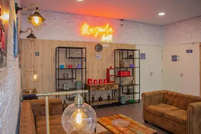 a kitchen with a wooden table and white chairs at Magnolia Suites & Stays in Porto