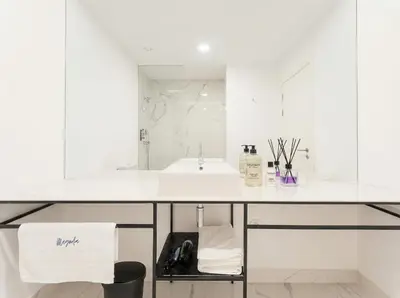 a kitchen with a sink and a counter with a microwave at Magnolia Suites & Stays in Porto