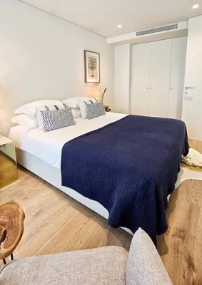 a bedroom with a bed and a rug on the floor at Central Apartment with parking/terrace in Porto