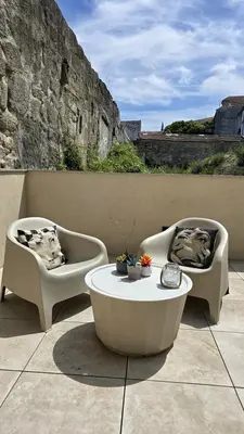 a patio with a table and chairs and an umbrella at Central Apartment with parking/terrace in Porto