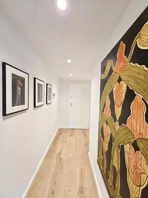 a room with a large painting on the wall at Central Apartment with parking/terrace in Porto