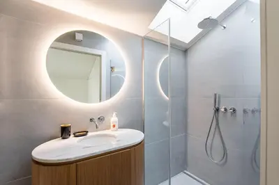 a bathroom with a sink and a shower with a mirror at GuestReady - Vera Cruz Apartments in Porto