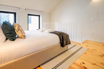 a bedroom with a large bed with white sheets at Luxury Style 4 with AC Downtown Porto near Metro in Porto