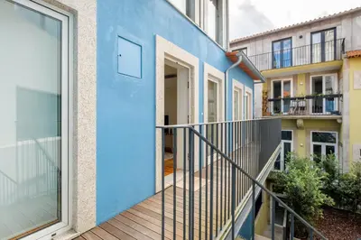 a house with a blue wall and a balcony at Luxury Style 4 with AC Downtown Porto near Metro in Porto