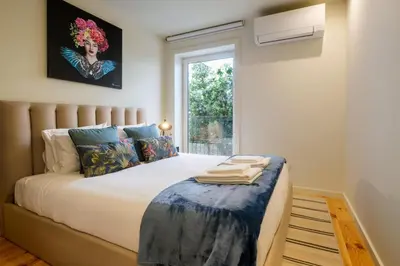 a bedroom with a large bed with a window at Luxury Style 7 with AC Downtown Porto near Metro in Porto
