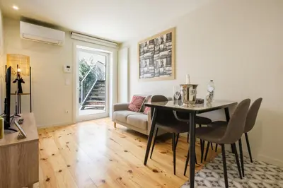 a living room with a table and a couch at Luxury Style 7 with AC Downtown Porto near Metro in Porto