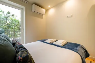 a bedroom with a bed and a window at Luxury Style 7 with AC Downtown Porto near Metro in Porto