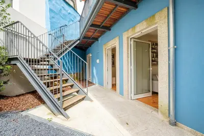 a staircase leading up to a blue house at Luxury Style 7 with AC Downtown Porto near Metro in Porto
