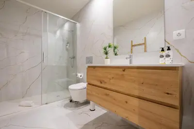 a bathroom with a shower and a toilet and a sink at Luxury Style 6 with AC Downtown Porto near Metro in Porto