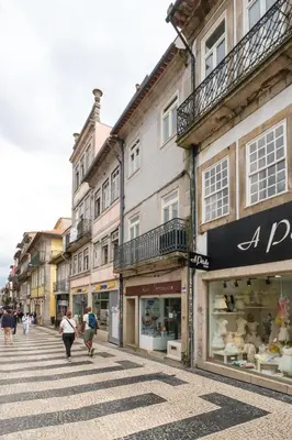 a group of people walking down a street with buildings at Cedofeita Sunshine Luxury Apartment Downtown Porto in Porto