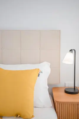 a bed with a yellow pillow and a lamp at Liiiving in Porto - Modern & Glam Apartment J in Porto
