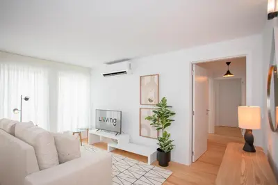 a white living room with a couch and a tv at Liiiving in Porto - Modern & Glam Apartment J in Porto
